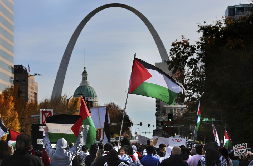 FILE - Marchers make their way east on Market Street toward the Gateway Arch to call attention to war in Palestine during a 'Day of Action' in St. Louis, on Nov. 9, 2023. The Missouri Chapter of the American Muslims for Palestine have called for ongoing protests and a ceasefire in Gaza during the war between Israel and Hamas. As the Israel-Hamas war rages in Gaza, there's a bitter battle for public opinion flaring in the U.S., with angry rallies and disruptive protests at prominent venues in several major cities. Among the catalysts are Palestinian and Jewish-led groups that have been active for years in opposing Israeli policies toward the Palestinians. Now many groups involved in those earlier efforts are playing a key role protesting the latest fighting, with actions on campuses and beyond. (Robert Cohen/St. Louis Post-Dispatch via AP, File)
