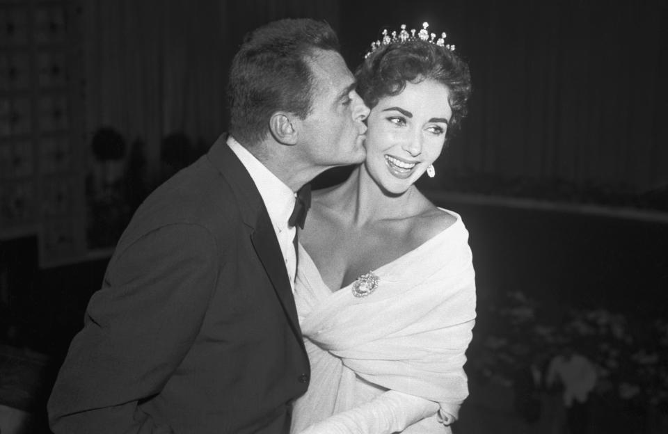 Elizabeth Taylor is kissed by her husband, producer Mike Todd, at the Cannes Film Festival, May 4, 1957. 