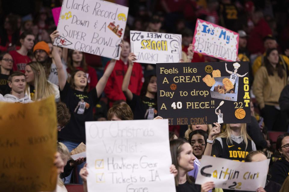 Fans hold signs in support of Iowa and Caitlin Clark before they play against Nebraska in an NCAA college basketball game Sunday, Feb. 11, 2024, in Lincoln, Neb. (AP Photo/Rebecca S. Gratz)