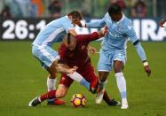 Football - Soccer - Lazio v AS Roma - Italian Serie A - Olympic Stadium, Rome, Italy - 4/12/2016. Lazio's Senad Lulic (L) and Keita fight for the ball with AS Roma's Radja Nainggolan. REUTERS/Alessandro Bianchi