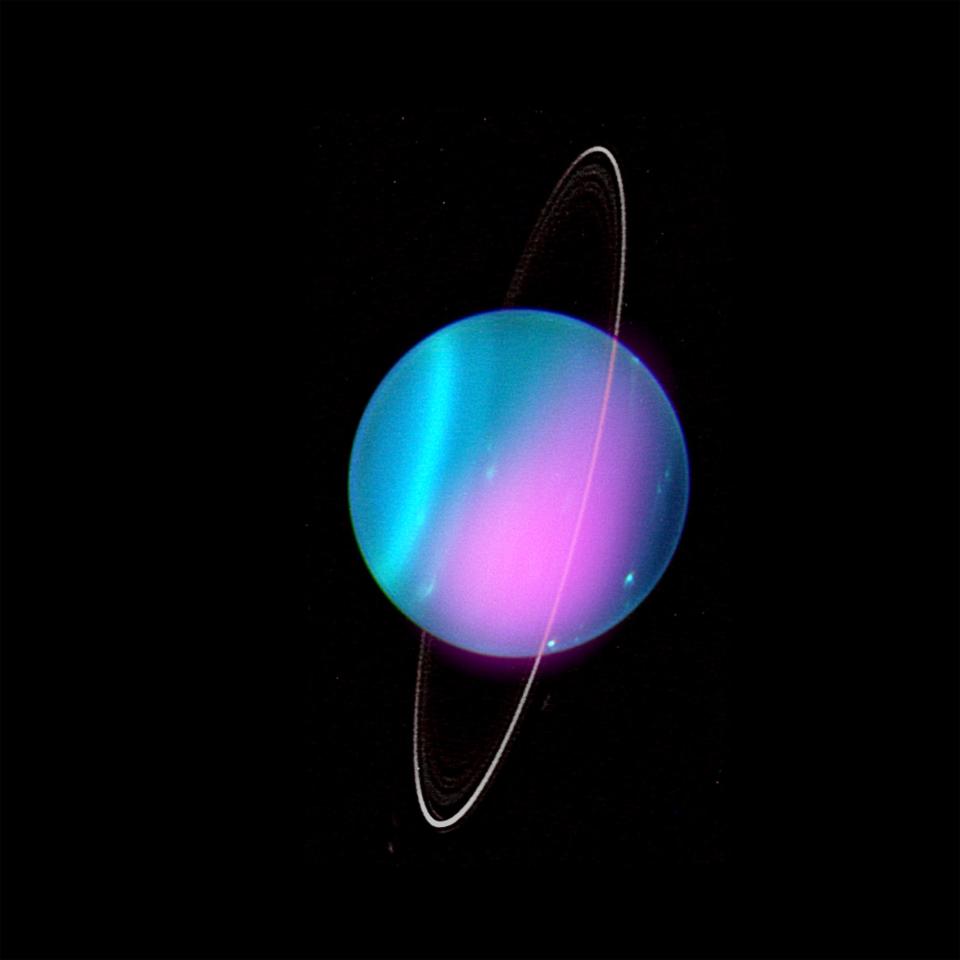 uranus blue tilted planet with faint white rings and a splash of pink across its center