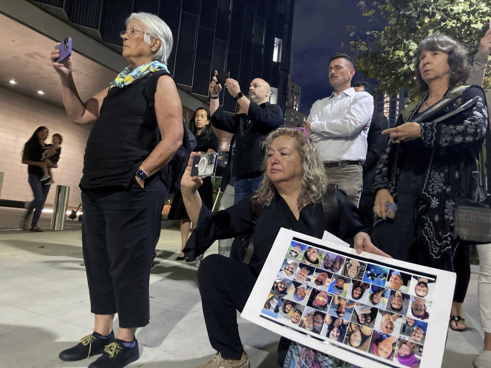 Family members applaud and cheer as U.S. Attorney Martin Estrada and prosectors walk out of the courthouse after a verdict at federal court in Los Angeles, Monday, Nov.6, 2023. A federal jury found that scuba dive boat captain Jerry Boylan was criminally negligent in the deaths of 34 people killed in a fire aboard the vessel in 2019, the deadliest maritime disaster in recent U.S. history. (AP Photo/Stefanie Dazio)