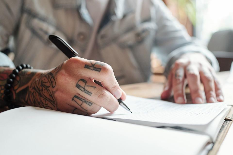 <p>Getty</p> A stock image of a person with tattoos