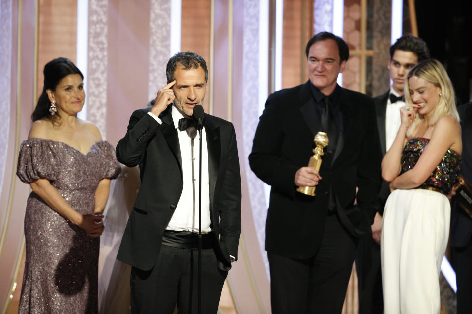 BEVERLY HILLS, CALIFORNIA - JANUARY 05: In this handout photo provided by NBCUniversal Media, LLC,  David Heyman accepts the award for BEST MOTION PICTURE – MUSICAL OR COMEDY for "Once Upon a Time...in Hollywood" onstage, with Shannon McIntosh, Quentin Tarantino, Golden Globe Ambassador Paris Brosnan and Margot Robbie, during the 77th Annual Golden Globe Awards at The Beverly Hilton Hotel on January 5, 2020 in Beverly Hills, California. (Photo by Paul Drinkwater/NBCUniversal Media, LLC via Getty Images)