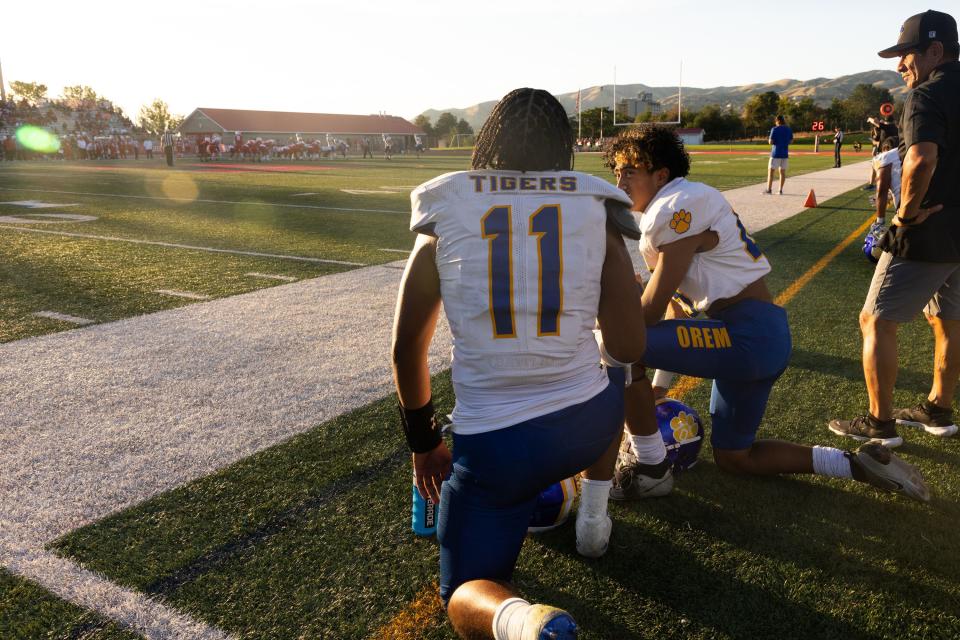 Orem players take a knee in their high school football season opener against East at East High School in Salt Lake City on Friday, Aug. 11, 2023. Despite being down 14-0 at the end of the first half, Orem came back to win 21-20. | Megan Nielsen, Deseret News