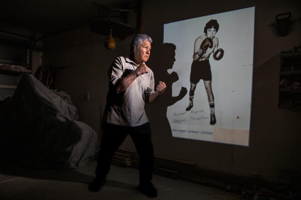 Gonzalo Montellano is shown shadow boxing in front of a boxing photo.