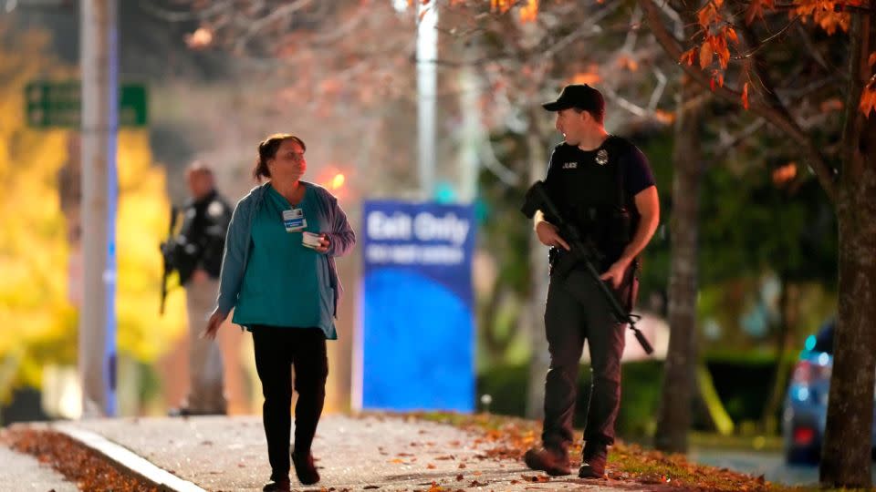 Law enforcement officers stand with rifles outside Central Maine Medical Center in Lewiston, Maine, on Wednesday. - Steven Senne/AP