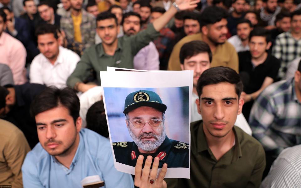 A man holds a picture of Zahedi