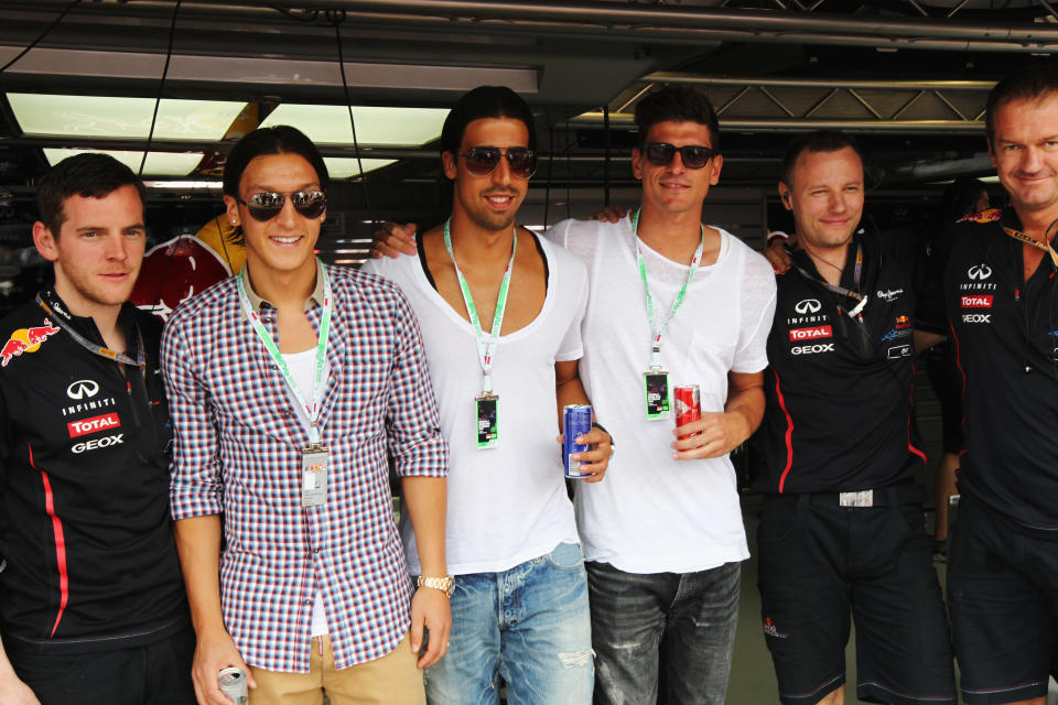 (L-R) German footballers Mesut Oezil, Sami Khedira and Mario Gomez are seen in the Red Bull Racing garage before the Monaco Formula One Grand Prix at the Circuit de Monaco on May 27, 2012 in Monte Carlo, Monaco. (Andrew Hone/Getty Images)