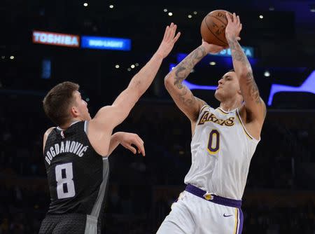 March 24, 2019; Los Angeles, CA, USA; Los Angeles Lakers forward Kyle Kuzma (0) shoots against Sacramento Kings guard Bogdan Bogdanovic (8) during the second half at Staples Center. Mandatory Credit: Gary A. Vasquez-USA TODAY Sports