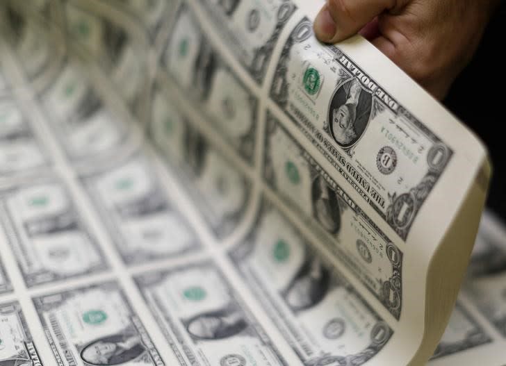 United States one dollar bills are curled and inspected during production at the Bureau of Engraving and Printing in Washington November 14, 2014. REUTERS/Gary Cameron