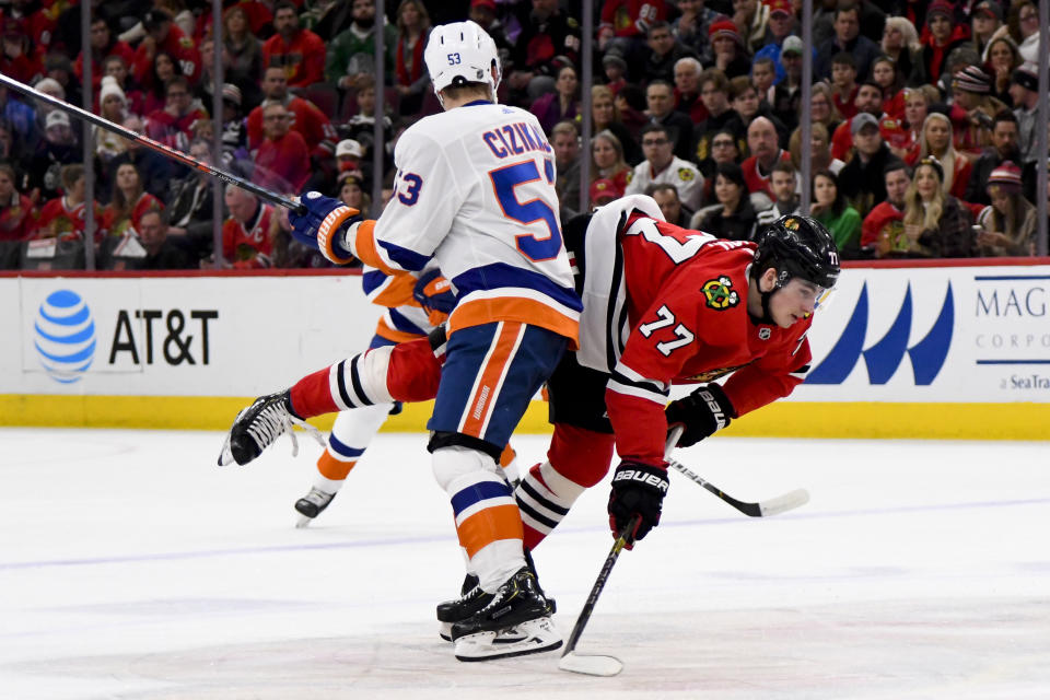 New York Islanders center Casey Cizikas (53) and Chicago Blackhawks center Kirby Dach (77) collide during the first period of an NHL hockey game Friday, Dec. 27, 2019, in Chicago. (AP Photo/Matt Marton)