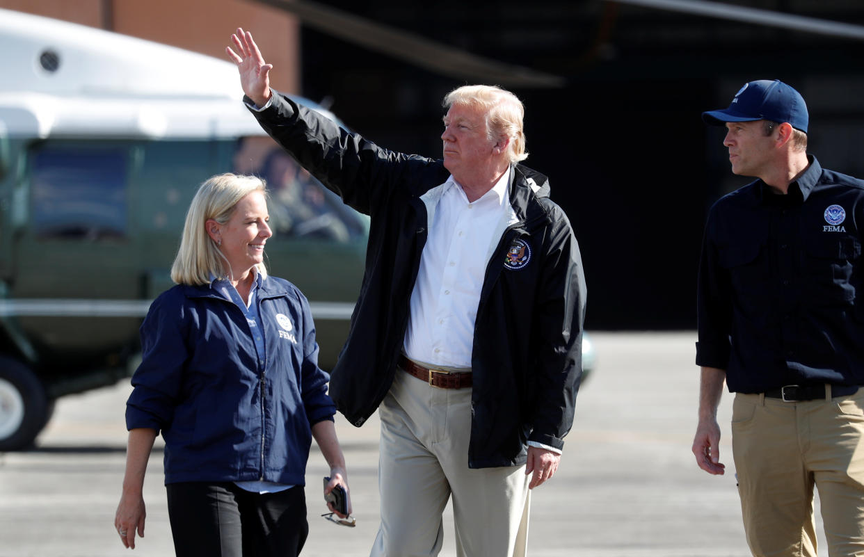 President Donald Trump waves as FEMA Director Brock Long and Homeland Security Secretary Kirstjen Nielsen walk Trump to Air Force One in Myrtle Beach, South Carolina, on Wednesday. (Photo: Kevin Lamarque / Reuters)