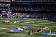 Australian and New Zealand players stand together as they play the national anthems before the start of their Cricket World Cup final match at the Melbourne Cricket Ground (MCG) March 29, 2015. REUTERS/David Gray