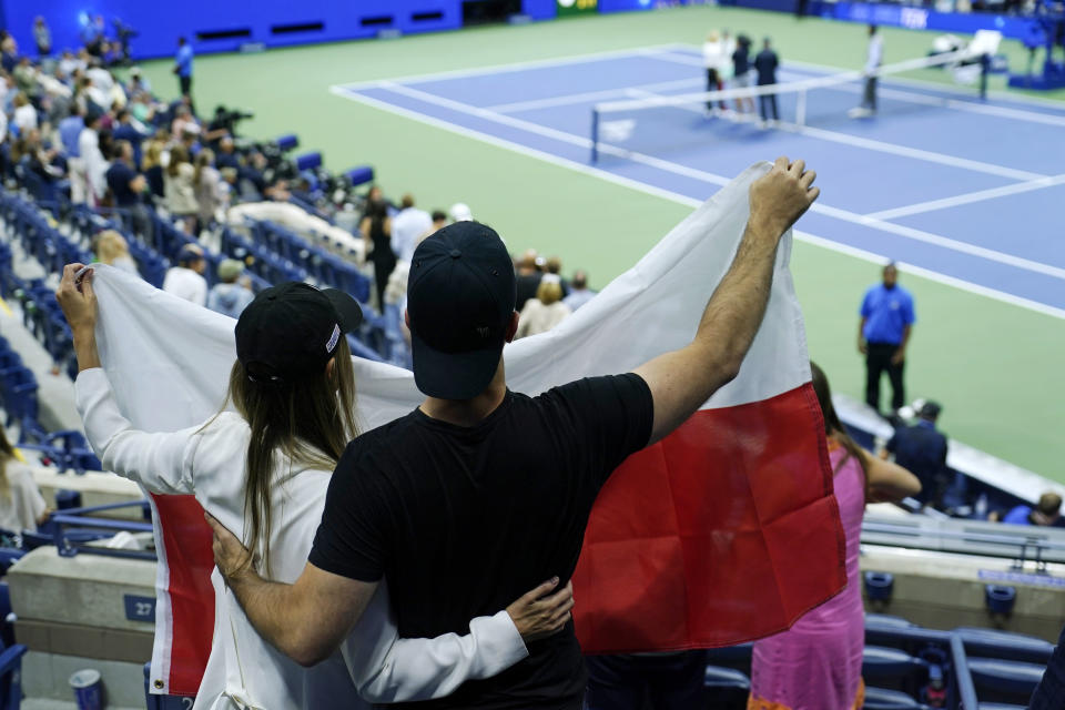 Fans of Iga Swiatek, of Poland, cheer after she defeated Aryna Sabalenka, of Belarus, in the semifinals of the U.S. Open tennis championships, Thursday, Sept. 8, 2022, in New York. (AP Photo/Julia Nikhinson)