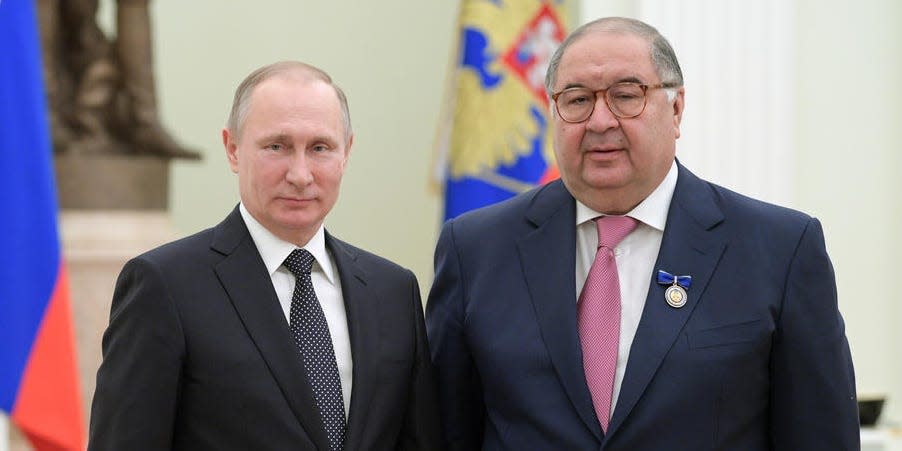 Russian President Vladimir Putin, left, poses for a photo with USM Holdings founder, businessman Alisher Usmanov during an awarding ceremony in Moscow's Kremlin, Russia, Thursday, Jan. 26, 2017