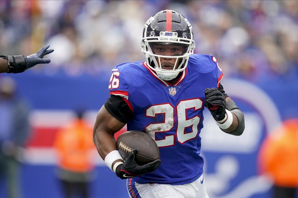 New York Giants running back Saquon Barkley (26) runs the ball against the Chicago Bears during the first quarter of an NFL football game, Sunday, Oct. 2, 2022, in East Rutherford, N.J. (AP Photo/John Minchillo)