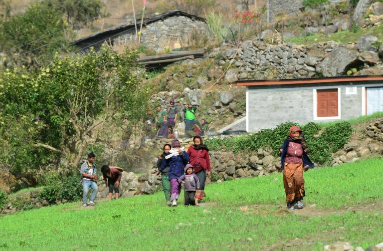 Nepalese villagers wait for the arrival of food and relief materials at Sirdibas village in Gorkha District