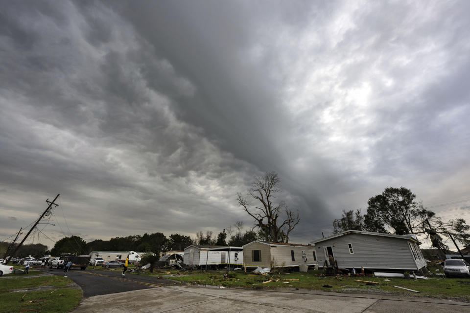 Dark clouds hang over Bradley Lane after a tornado destroyed several mobile homes in the area, Wednesday, Dec. 14, 2022, in New Iberia, La. (Leslie Westbrook/The Times-Picayune/The New Orleans Advocate via AP)