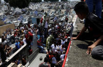 Relatives and friends of goalkeeper Christian Esmerio, 15, attend his burial after a deadly fire at Flamengo soccer club's training center, in Rio de Janeiro, Brazil February 10, 2019. REUTERS/Ricardo Moraes