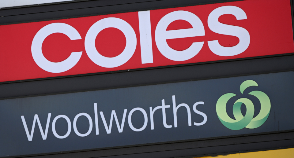 Coles Woolworths supermarket signs.