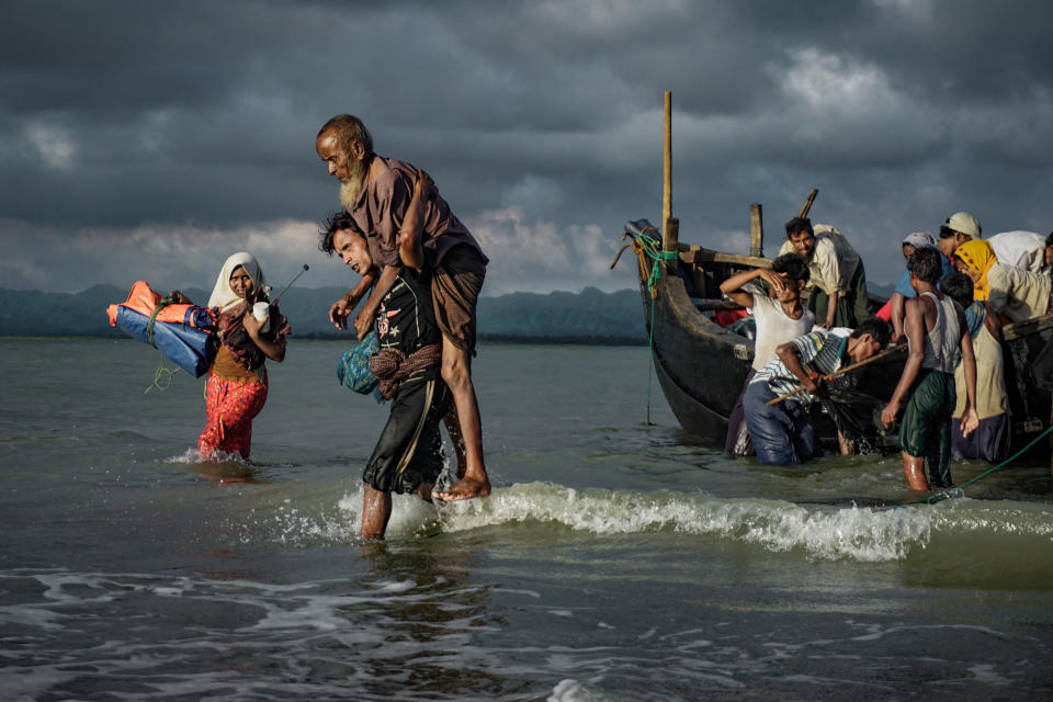 Rohingya Muslim refugees disembark from a boat on the Bangladeshi side of Naf river in Teknaf on Sept. 13, 2017.