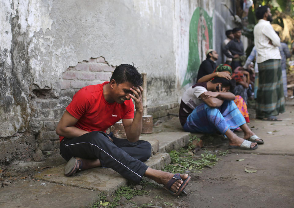 An unidentified Bangladeshi cries by the site of a fire that broke out late Wednesday in closely set buildings in Dhaka, Bangladesh, Thursday, Feb. 21, 2019. A devastating fire raced through at least five buildings in an old part of Bangladesh's capital and killed scores of people. (AP Photo/Rehman Asad)