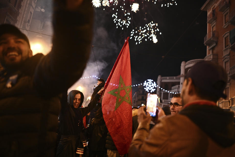 Morocco's fans celebrate after their team won the match against Spain at the World Cup soccer tournament in Qatar, in Turin, Italy, Tuesday, Dec. 6, 2022. (Marco Alpozzi/LaPresse via AP)