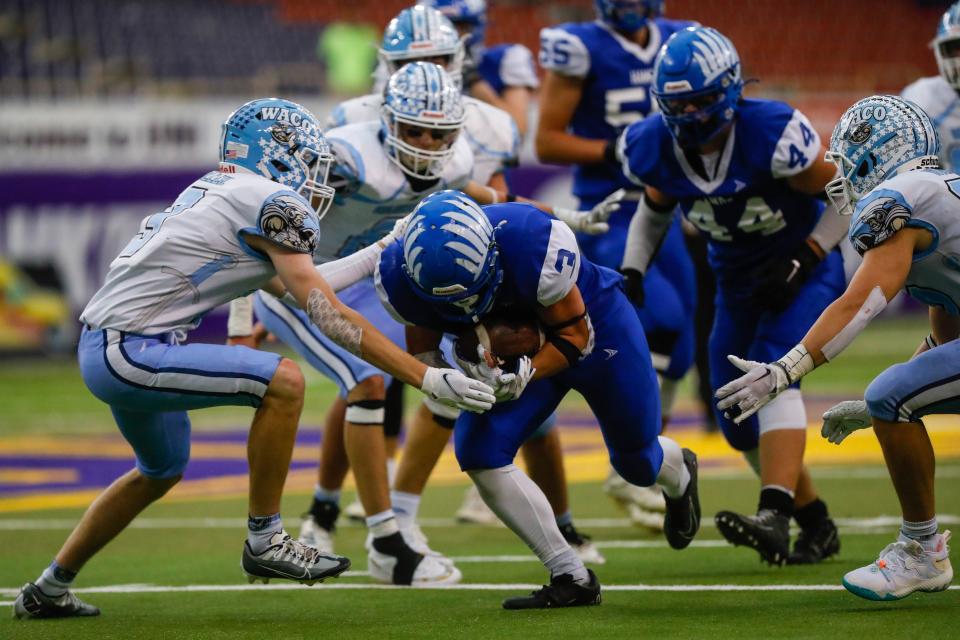 St. Mary's Remse running back Alex Schroeder (3) tries to break through WACO defensive back Mason Miller’s (3) tackle during the eight-man playoff finals Thursday, Nov. 17, 2022, at the UNI-Dome in Cedar Falls. The Hawks defeated the Warriors, 38-16.