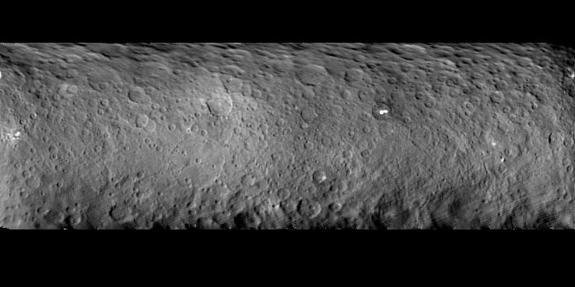 Ceres is covered with many craters, as seen in this mosaic comprised of images taken by NASA's Dawn spacecraft on Feb. 19, 2015 from a distance of nearly 29,000 miles (46,000 kilometers). One Ceres crater houses two mysterious bright spots, whi