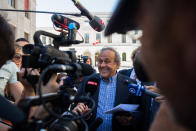 The former president of the the European Football Association (Uefa), Michel Platini, center, surrounded by media representatives, speaks to the press in front of the Swiss Federal Criminal Court in Bellinzona, Switzerland, at the last day of the trail, after the verdict has been announced, Friday, July 8, 2022. The trial ended with an acquittal. Former Fifa President Joseph Blatter and Platini, stood trial before the Federal Criminal Court over a suspicious two-million payment. The Federal Prosecutor's Office accused them of fraud. The defense spoke of a conspiracy. (Ti-Press/Alessandro Crinari/Keystone via AP)