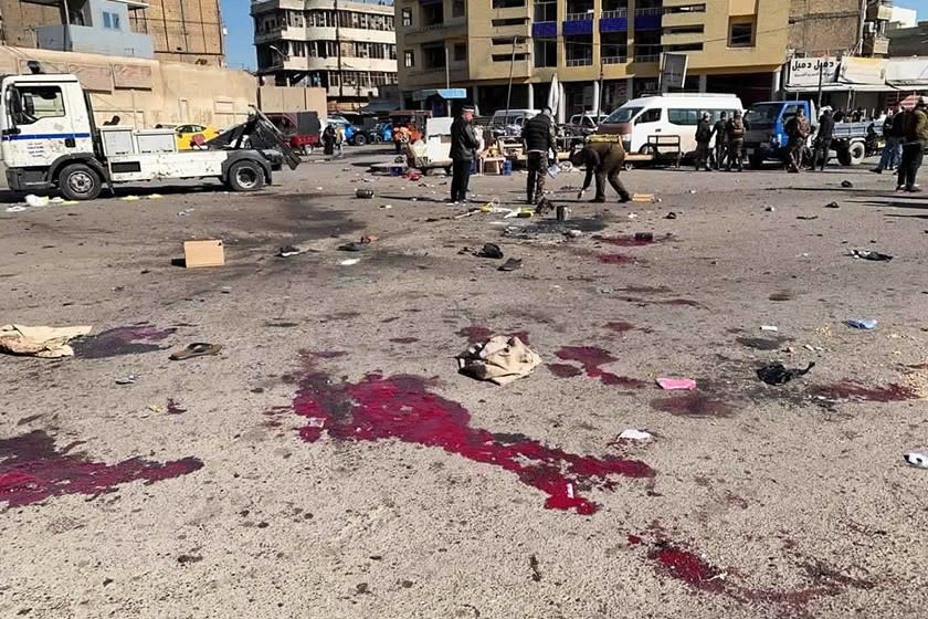 Iraqi security forces at the site of a deadly bomb attack in a Baghdad commercial area on Thursday.