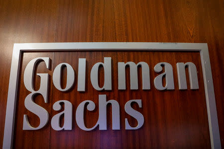 FILE PHOTO: The Goldman Sachs company logo is seen in the company's space on the floor of the New York Stock Exchange, (NYSE) in New York, U.S., April 17, 2018. REUTERS/Brendan McDermid