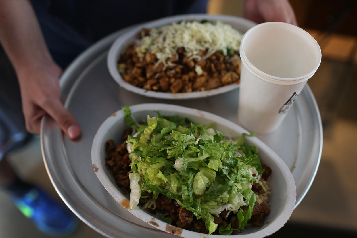 MIAMI, FL - APRIL 27:  A customer carries a tray with his Chipotle food order, on the day that the company announced it will only use non-GMO ingredients in its food on April 27, 2015 in Miami, Florida.  The company announced, that the Denver-based chain would not use the GMO's, which is an organism whose genome has been altered via genetic engineering in the food served at Chipotle Mexican Grills.  (Photo by Joe Raedle/Getty Images)