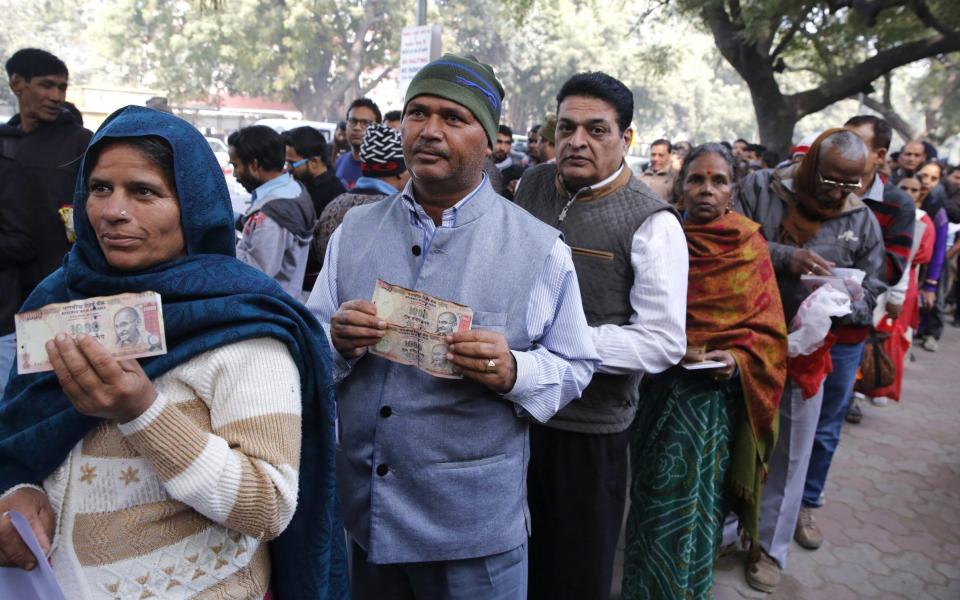 Indian savers with cash - Credit: Rajat Gupta/EPA