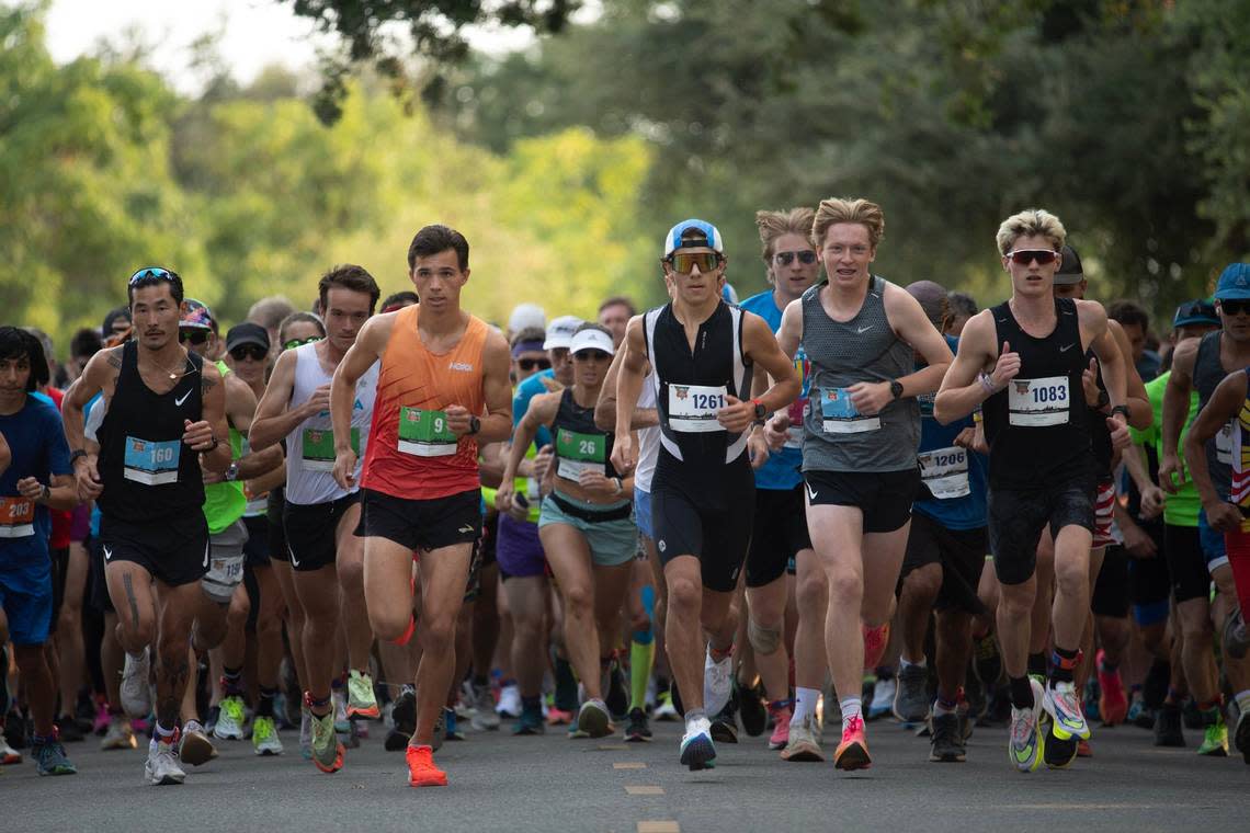 Runners leave the starting line at the start of the Great American Triathlon on Saturday, July 20, 2024.