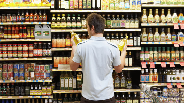 man choosing cooking oil