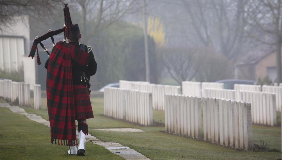 A Scottish Battalion piper plays the lament during the reburial service of British World War One soldier William McAleer at the Loos British World War One cemetery in Loos-en-Gohelle, France on Friday, March 14, 2014. Private William McAleer, of the 7th Battalion, Royal Scots Fusiliers, was killed in action on Sept. 26, 1915 during the Battle of Loos. His body was found and identified in 2010 during routine construction in the area and is being reburied with full military honors. (AP Photo/Virginia Mayo)
