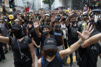 Protestors shout slogans in Hong Kong, Sunday, Sept. 29, 2019. Protesters and police clashed in Hong Kong for a second straight day on Sunday, throwing the city's business and shopping belt into chaos and sparking fears of more ugly scenes leading up to China's National Day this week. (AP Photo/Gemunu Amarasinghe)