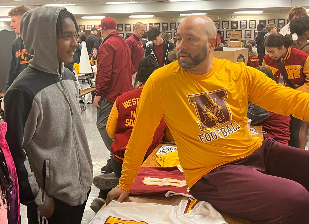 Former Ohio State quarterback Stanley Jackson Sr. talks with Jayden Smith, an eighth-grader at Heritage Middle School, during an informational meeting with middle school athletes and parents Monday at Westerville North. Pending school board approval, Jackson will be next football coach at North.