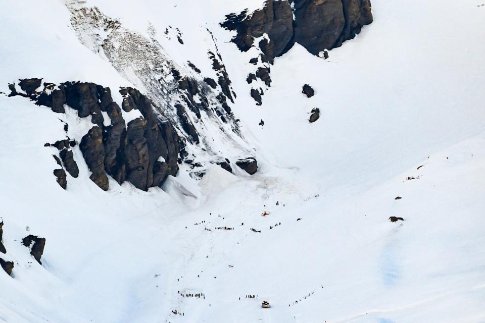 Rescue crew work on the avalanche site in the ski resort of Crans-Montana (EPA)