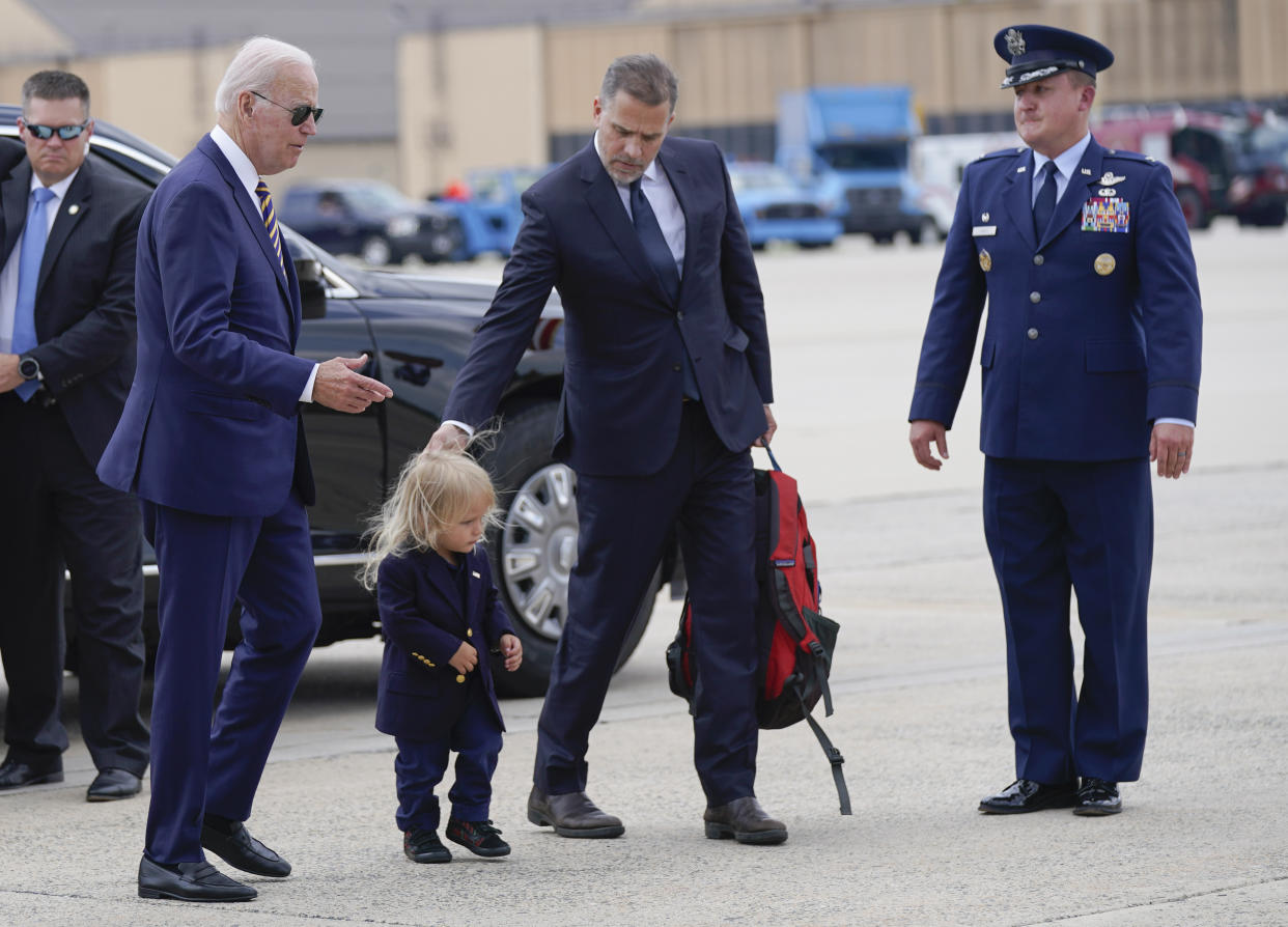 President Joe Biden walks with his son Hunter Biden and grandson Beau Biden to board Air Force One at Andrews Air Force Base, Md., Wednesday, Aug. 10, 2022. The President is traveling to Kiawah Island, S.C., for vacation. (AP Photo/Manuel Balce Ceneta)