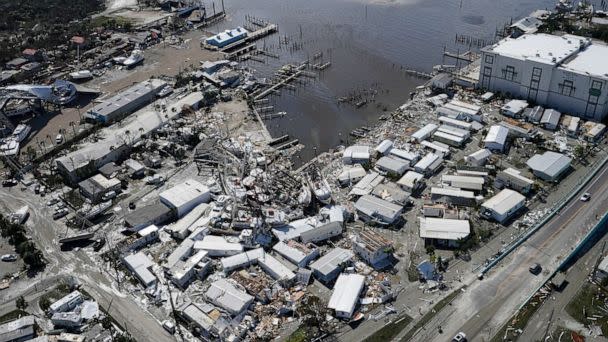 PHOTO: Damages boats lie on the land and water in the aftermath of Hurricane Ian, Sept. 29, 2022, in Fort Myers, Fla. (Wilfredo Lee/AP)