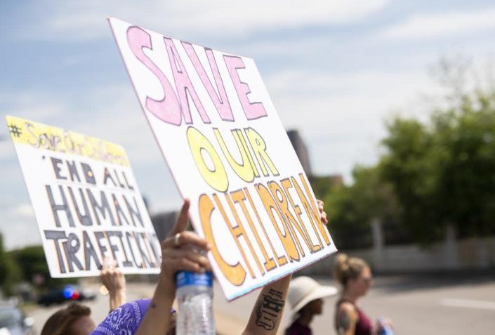 People march during a &quot;Save the Children&quot; rally outside the Capitol on Aug. 22, 2020, in St. Paul, Minn.