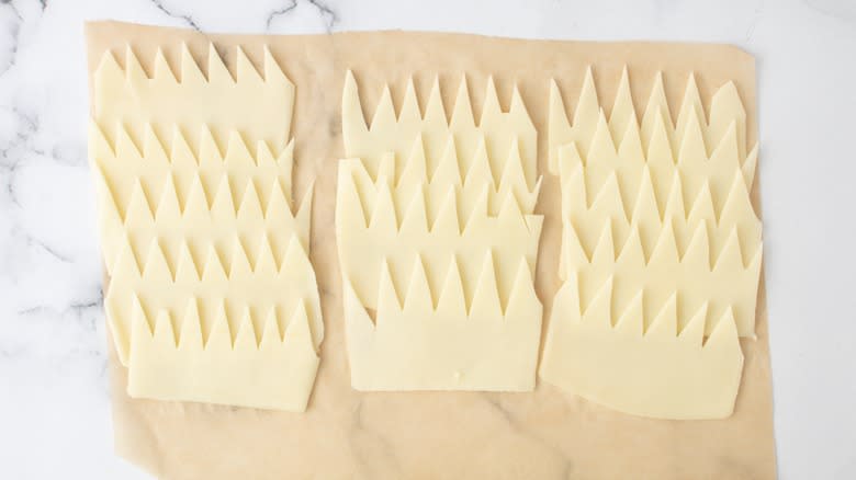 sliced cheese cut into spiky pattern