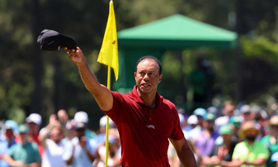 <span>Tiger Woods acknowledges the crowd on the green on the 18th hole after completing his final round.</span><span>Photograph: Mike Blake/Reuters</span>