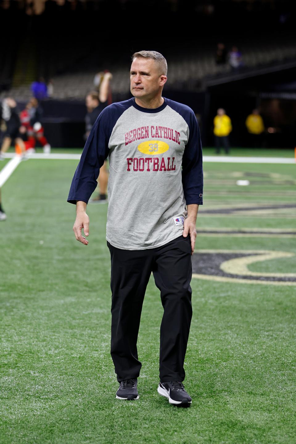 New Orleans Saints special teams coordinator Darren Rizzi wears a Bergen Catholic Football shirt before an NFL football game against the New York Giants, Sunday, Dec. 17, 2023, in New Orleans. (AP Photo/Tyler Kaufman)