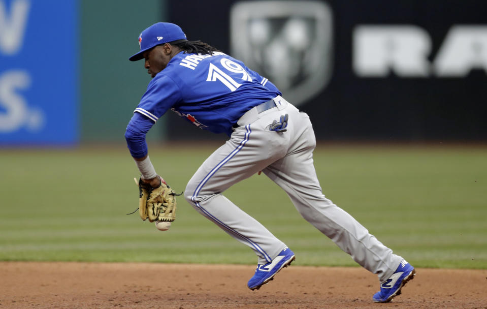 Toronto Blue Jays Alen Hanson bobbles the ball hit by Cleveland Indians' Tyler Naquin in the third inning of a baseball game, Thursday, April 4, 2019, in Cleveland. Naquin was safe at first base. (AP Photo/Tony Dejak)