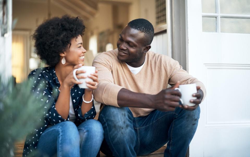 couple drinking coffee on steps outside