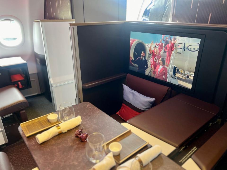 Virgin's A330neo cabin showing the Retreat Suite with its table out and TV on.